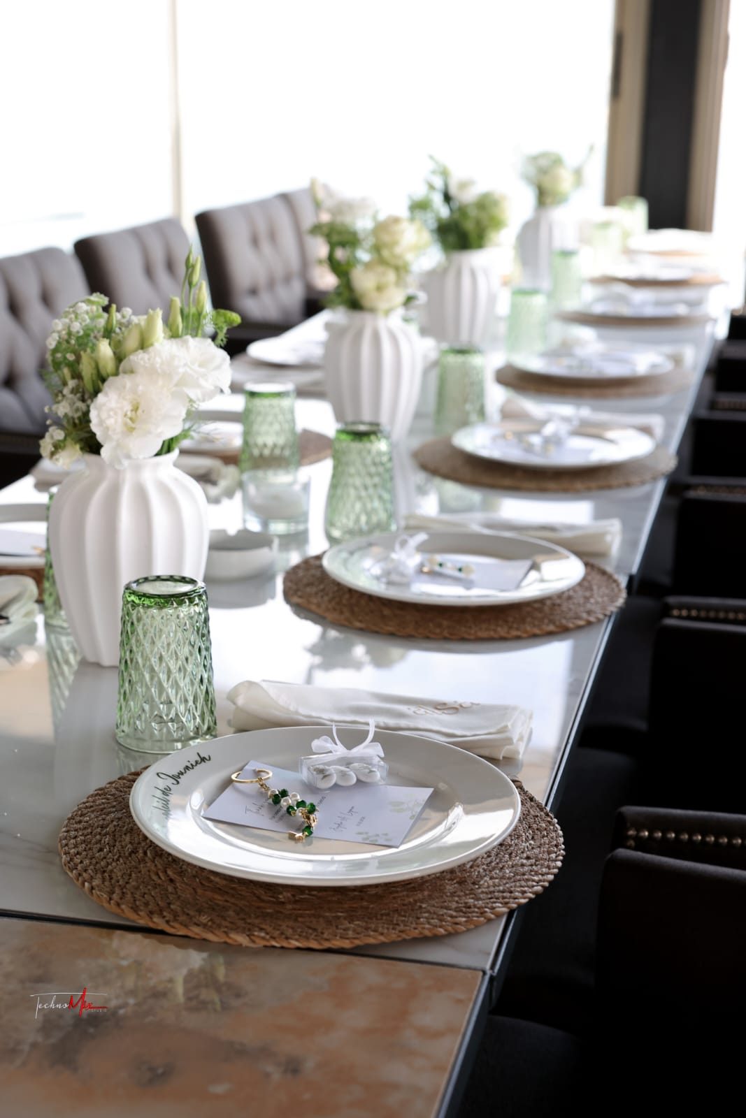 ALSA event table with green glasses and white flowers
