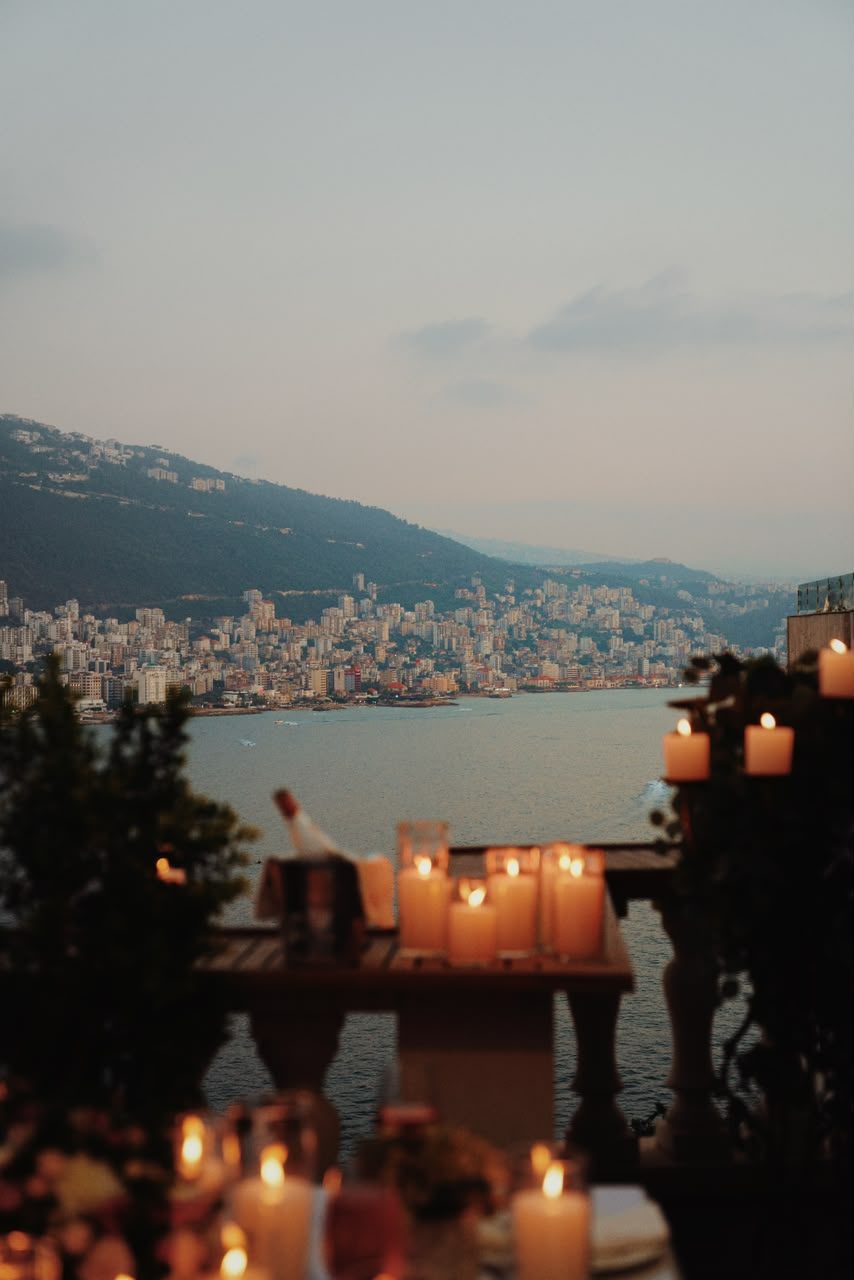 Candles on the terrace with Jounieh Bay at dusk