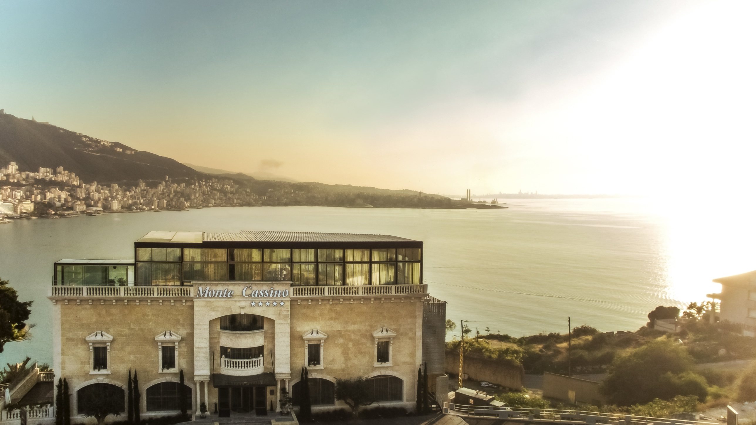 Monte Cassino Boutique Hotel facade above Jounieh Bay at sunset