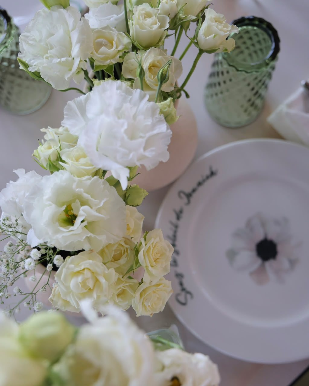 White roses beside a hand-lettered ALSA plate